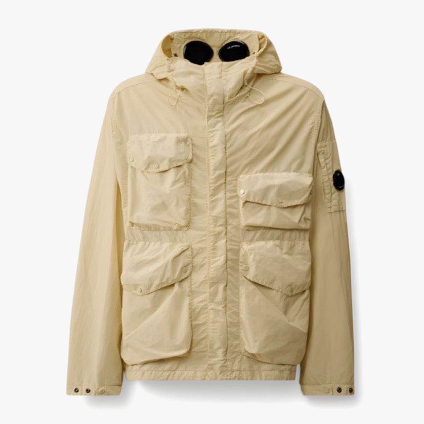 Veste Sahara de CP Company en collaboration avec RÆW DISTRICT, veste beige avec capuche et fermeture éclair visible.